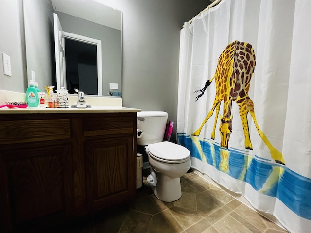 full bathroom with vanity, tile patterned floors, toilet, and shower / bath combo with shower curtain