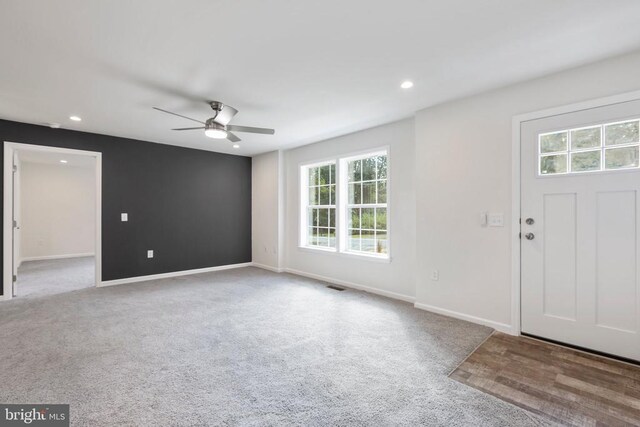 foyer with light carpet and ceiling fan