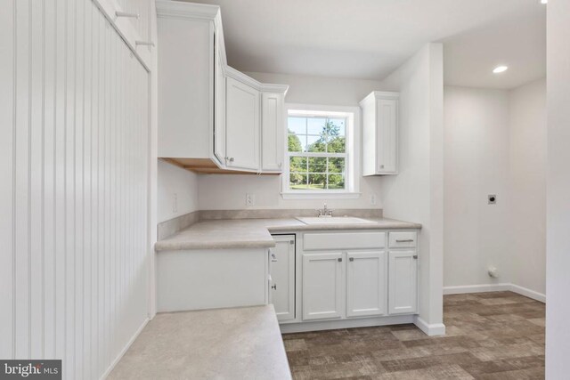 kitchen with white cabinetry and sink