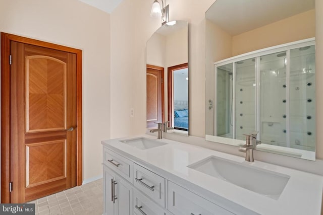 bathroom with vanity and a shower with door