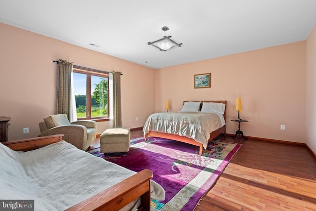 bedroom with hardwood / wood-style floors