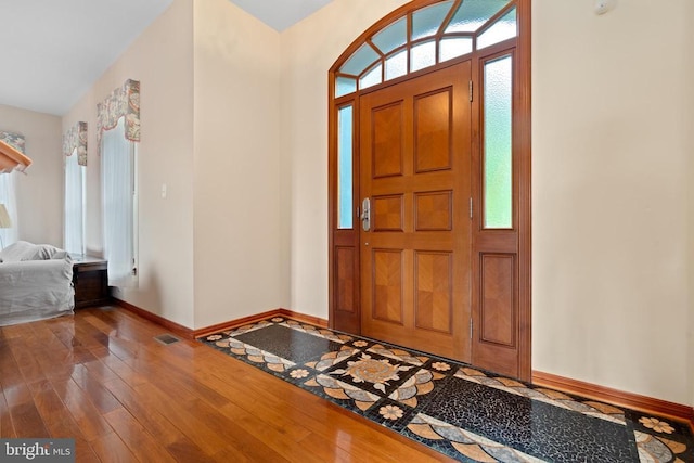 foyer with plenty of natural light and dark hardwood / wood-style floors