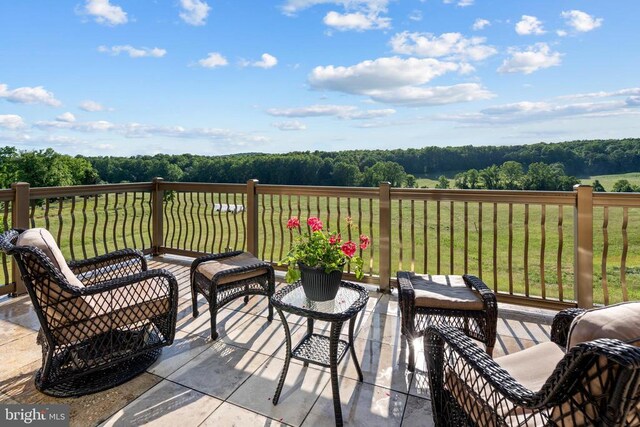 wooden terrace featuring a lawn