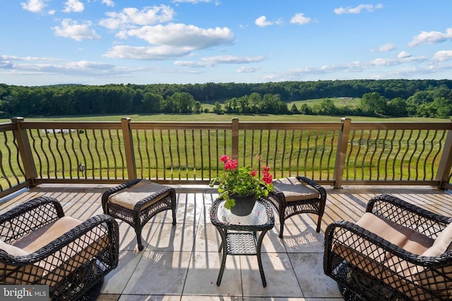 wooden terrace featuring a lawn