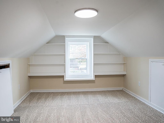 bonus room featuring carpet flooring and vaulted ceiling