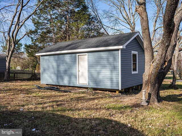 view of outbuilding with a yard