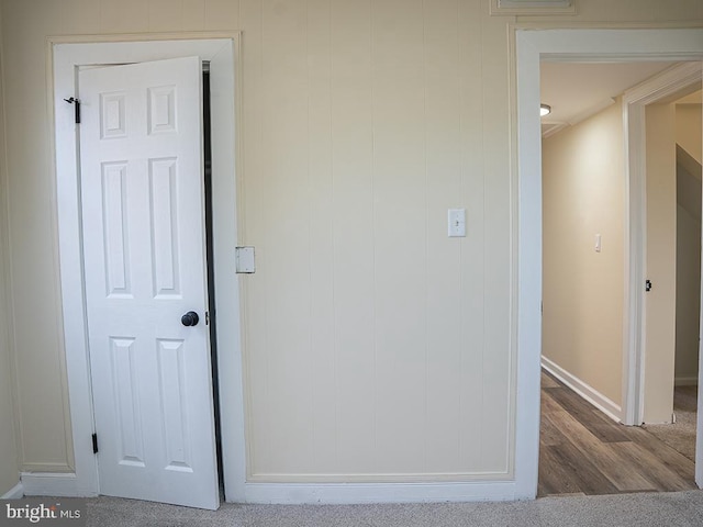 corridor with wood-type flooring