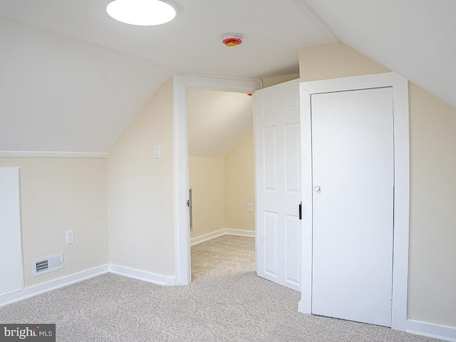 additional living space featuring light carpet and lofted ceiling