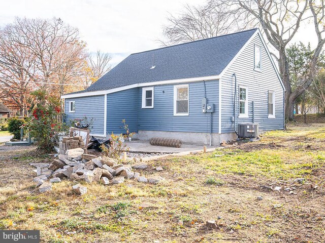 rear view of property with cooling unit and a patio area