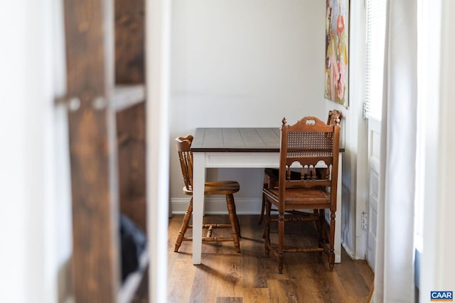 dining room featuring baseboards and wood finished floors