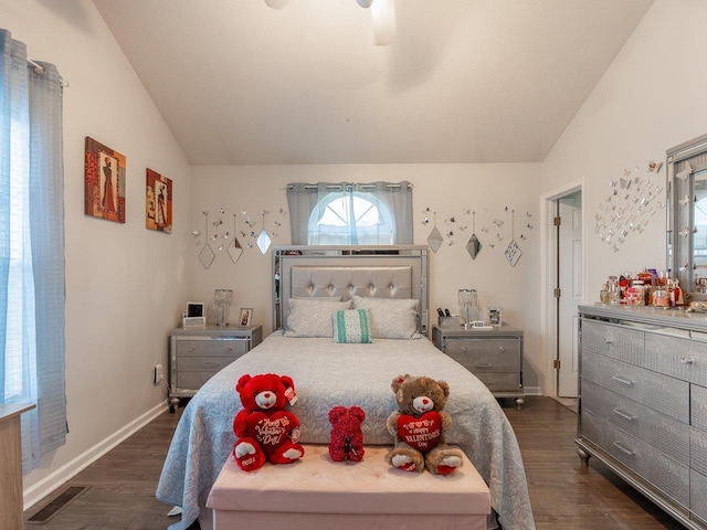 bedroom with lofted ceiling, dark hardwood / wood-style floors, and ceiling fan