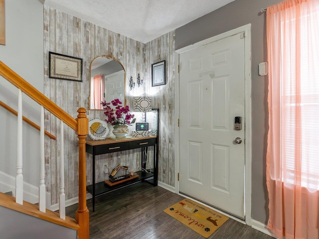 entryway featuring a textured ceiling and dark hardwood / wood-style flooring