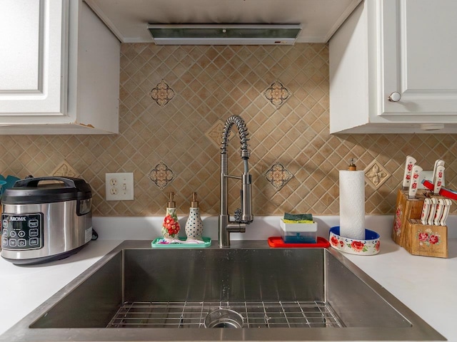 kitchen with white cabinetry, sink, and decorative backsplash