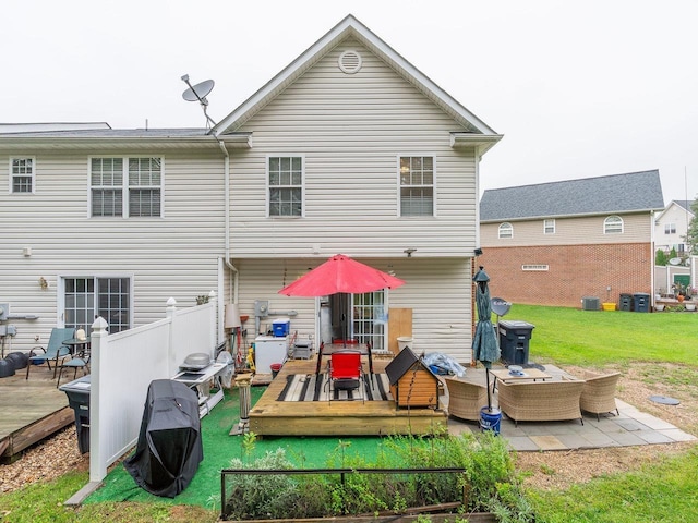 back of house featuring a wooden deck, a lawn, and outdoor lounge area