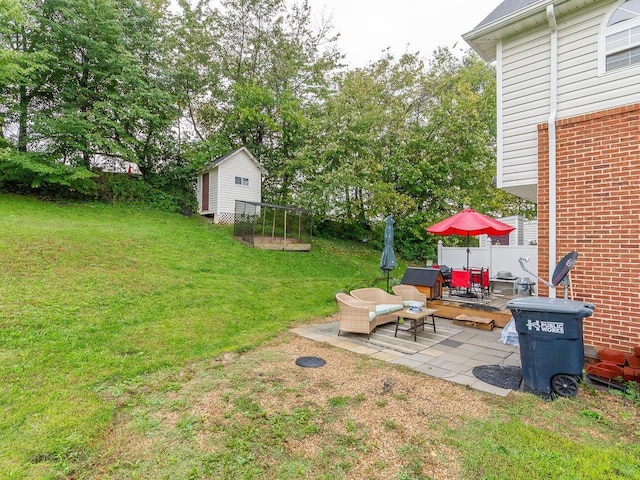 view of yard featuring a storage shed, an outdoor living space, and a patio