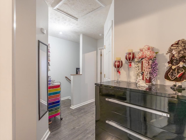 bathroom with hardwood / wood-style floors and a textured ceiling