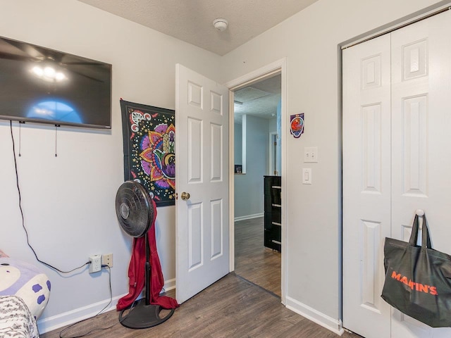 interior space with dark hardwood / wood-style floors and a textured ceiling