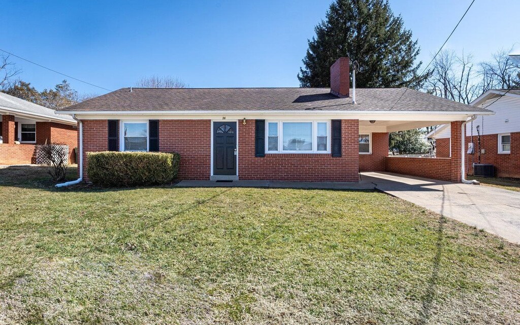 single story home featuring cooling unit and a carport