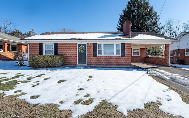 single story home featuring cooling unit and a carport