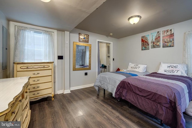 bedroom with dark wood-style floors and baseboards