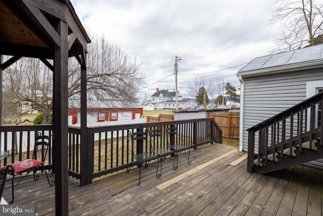 wooden deck with an outbuilding and fence