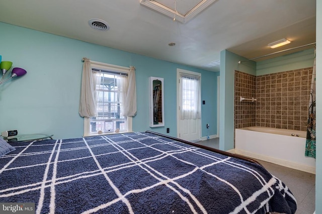 unfurnished bedroom featuring visible vents and attic access