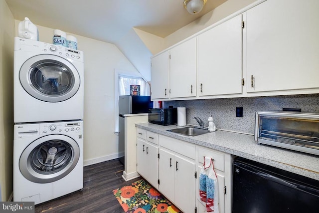 clothes washing area with a toaster, laundry area, stacked washer and clothes dryer, dark wood-style floors, and a sink