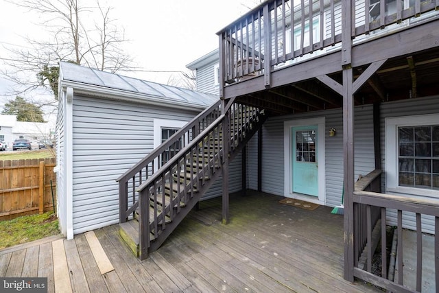 wooden terrace featuring stairs and fence