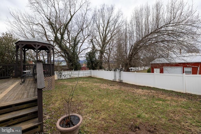 view of yard featuring a gazebo, a fenced backyard, and a wooden deck