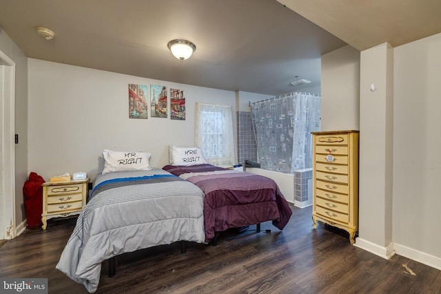 bedroom featuring wood finished floors and baseboards