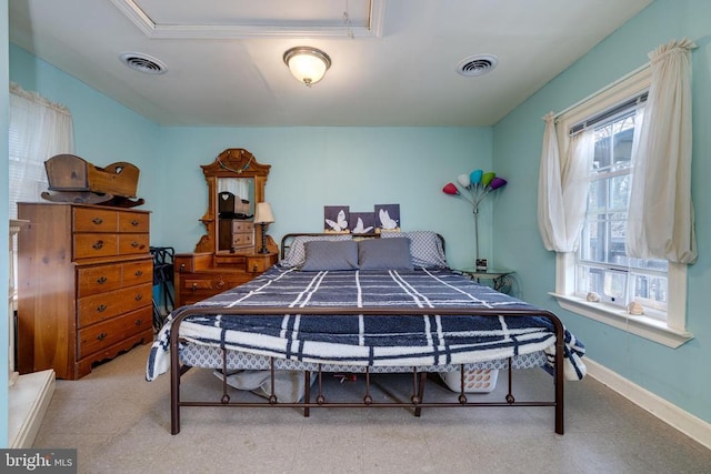 bedroom featuring tile patterned floors, visible vents, and baseboards