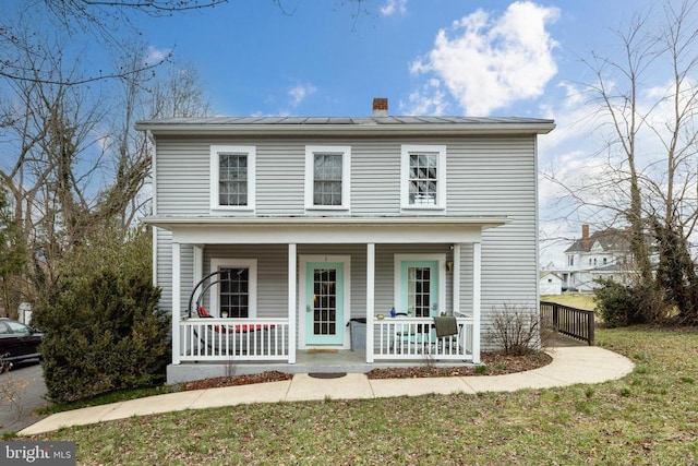 view of front of house featuring a porch and a chimney