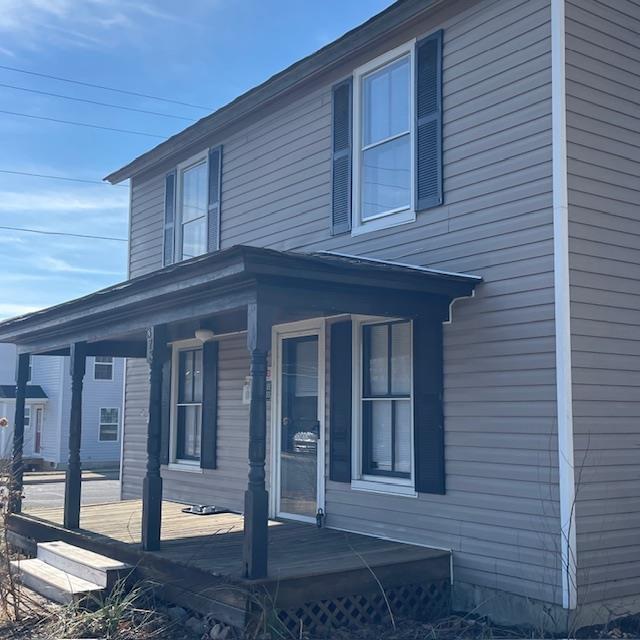 view of property exterior featuring covered porch