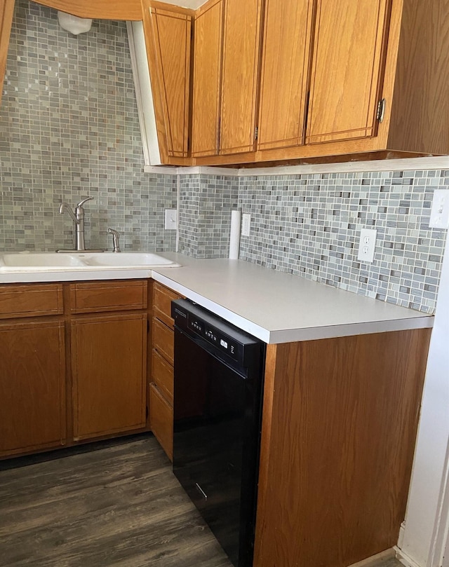 kitchen with black dishwasher, sink, backsplash, and dark hardwood / wood-style floors