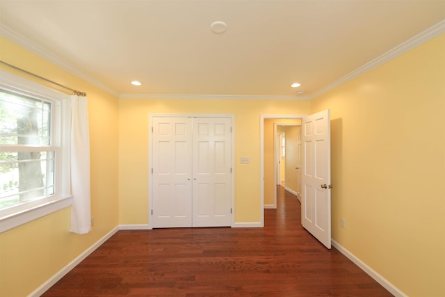 unfurnished bedroom featuring crown molding, recessed lighting, a closet, dark wood-type flooring, and baseboards