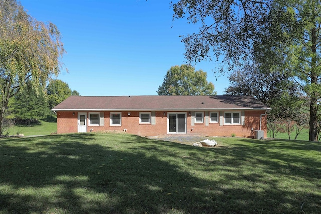 back of house with a yard, brick siding, and a patio area