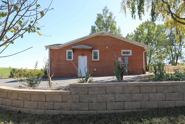 view of side of property featuring fence and brick siding