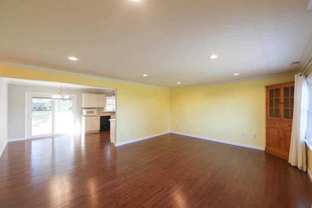 unfurnished living room featuring dark wood-type flooring, ornamental molding, and baseboards