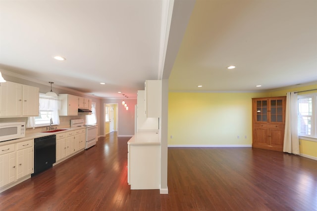 kitchen with dark wood-style floors, light countertops, a sink, white appliances, and under cabinet range hood