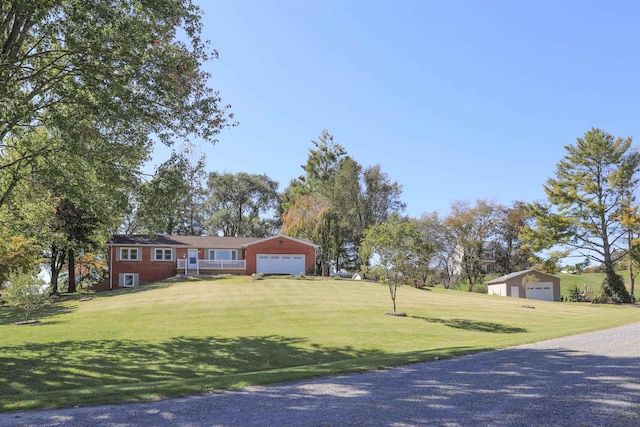 ranch-style home featuring a garage and a front yard