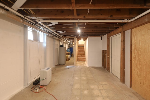 below grade area featuring gas water heater and stairs