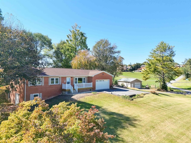 single story home featuring a front yard, concrete driveway, brick siding, and an attached garage