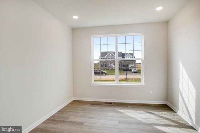 empty room with light hardwood / wood-style flooring