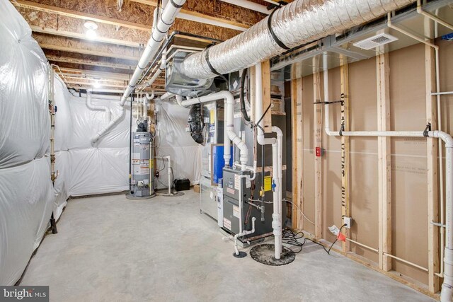 basement with water heater and heating unit