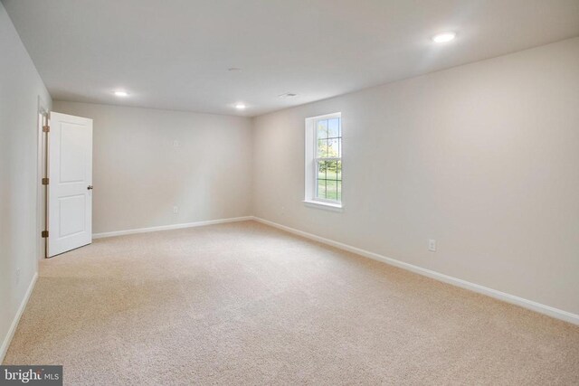 unfurnished room with light carpet