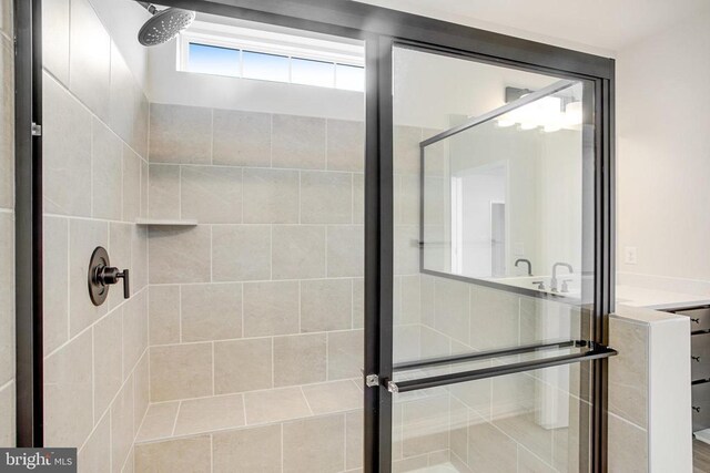 bathroom featuring a shower with shower door