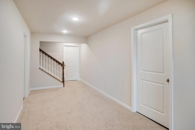 basement featuring light colored carpet