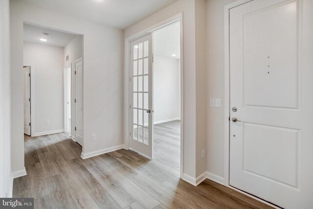 foyer entrance with light hardwood / wood-style floors