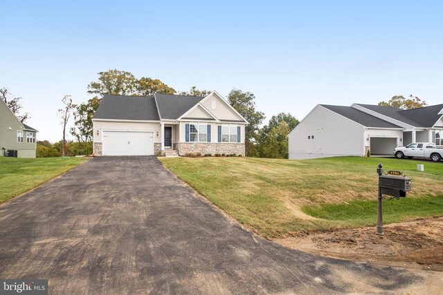 view of front of house with a garage and a front lawn