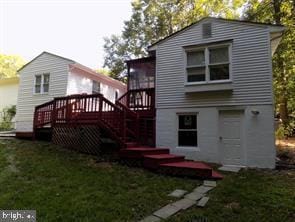 rear view of house with a deck, stairway, and a lawn